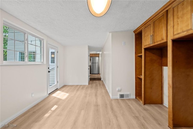 3695 S Hametown Rd, Norton, OH 44203 - mudroom with light wood finished floors and a textured ceiling