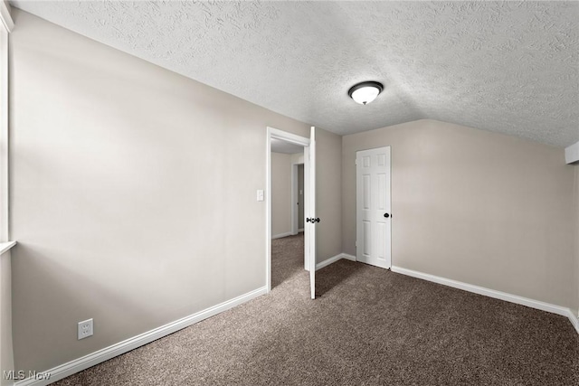 3695 S Hametown Rd, Norton, OH 44203 - additional living space with dark carpet, a textured ceiling, and lofted ceiling