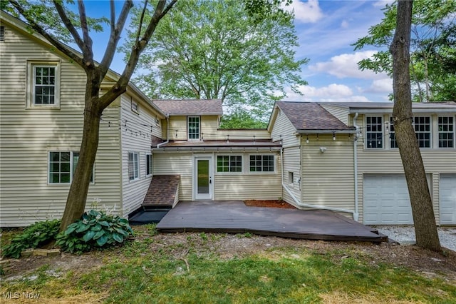 3695 S Hametown Rd, Norton, OH 44203 - rear view of property with a deck, a shingled roof, and a garage
