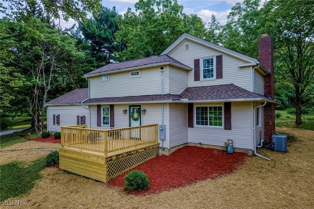 3695 S Hametown Rd, Norton, OH 44203 - back of house featuring a chimney, a shingled roof, a deck, and view of scattered trees