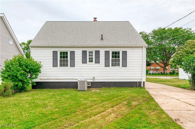 22100 Priday Ave, Euclid, OH 44123 - view of property exterior featuring a yard, a chimney, and a shingled roof