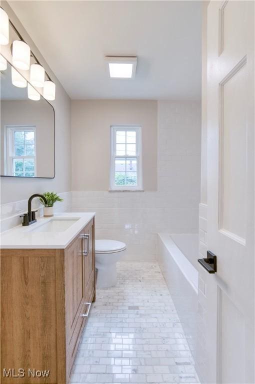 22100 Priday Ave, Euclid, OH 44123 - full bath with vanity, a tub to relax in, and tile walls