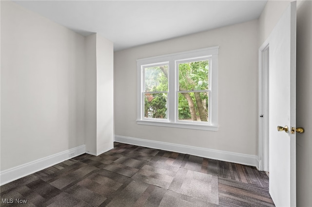 18830 Monterey Ave, Euclid, OH 44119 - spare room with dark carpet and baseboards