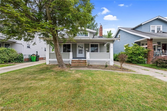 18830 Monterey Ave, Euclid, OH 44119 - bungalow-style house with covered porch, a front lawn, and a chimney