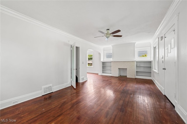18830 Monterey Ave, Euclid, OH 44119 - unfurnished living room with arched walkways, hardwood / wood-style flooring, ceiling fan, ornamental molding, and a brick fireplace