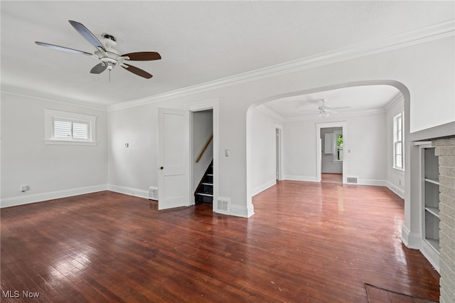 18830 Monterey Ave, Euclid, OH 44119 - unfurnished living room featuring a ceiling fan, arched walkways, hardwood / wood-style flooring, stairs, and crown molding