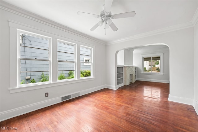 18830 Monterey Ave, Euclid, OH 44119 - unfurnished living room with hardwood / wood-style floors, crown molding, arched walkways, a fireplace, and a ceiling fan