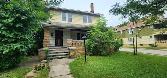 3624 E 154th St, Cleveland, OH 44120 - american foursquare style home with a porch, a chimney, and a front yard