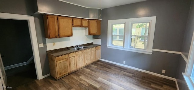 3624 E 154th St, Cleveland, OH 44120 - kitchen featuring dark countertops, dark wood-style flooring, and brown cabinetry