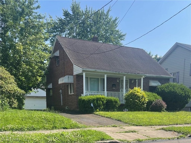 1068 Wyley Ave, Akron, OH 44306 - bungalow-style home with covered porch, brick siding, a front lawn, a chimney, and roof with shingles
