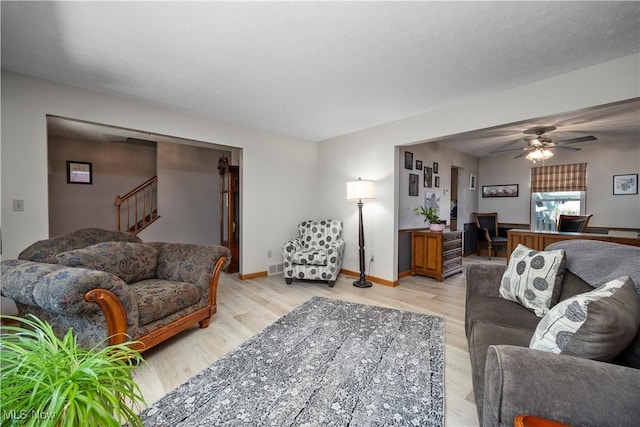 23730 Sawmill Bnd, Olmsted Falls, OH 44138 - living room with light wood-style floors, a ceiling fan, and stairs