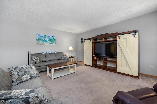 23730 Sawmill Bnd, Olmsted Falls, OH 44138 - living area featuring a barn door, a textured ceiling, and carpet flooring