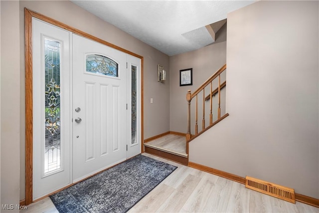 23730 Sawmill Bnd, Olmsted Falls, OH 44138 - entryway with stairs, plenty of natural light, and wood finished floors