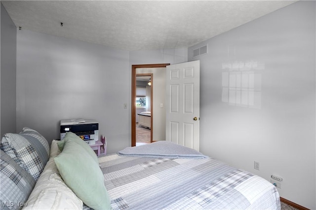 23730 Sawmill Bnd, Olmsted Falls, OH 44138 - bedroom featuring a textured ceiling and baseboards