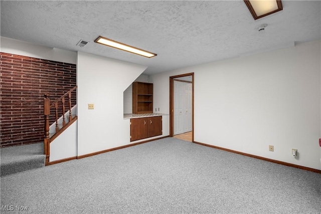 23730 Sawmill Bnd, Olmsted Falls, OH 44138 - basement with carpet floors, stairway, a textured ceiling, and brick wall