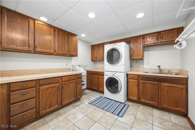 23730 Sawmill Bnd, Olmsted Falls, OH 44138 - laundry area with estacked washer and dryer, recessed lighting, light tile patterned floors, and cabinet space