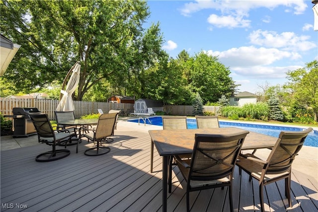 23730 Sawmill Bnd, Olmsted Falls, OH 44138 - wooden deck with outdoor dining area, a grill, a fenced backyard, and a storage shed