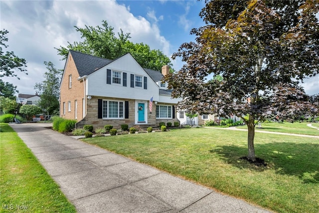 9013 Elsmere Dr, Parma, OH 44130 - view of front facade featuring stone siding, a front lawn, and a chimney