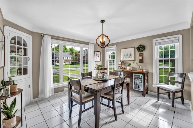 9013 Elsmere Dr, Parma, OH 44130 - dining room featuring light tile patterned floors and a chandelier