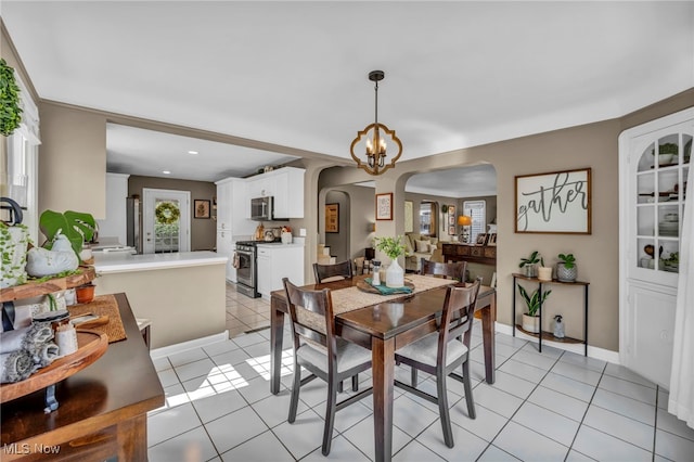 9013 Elsmere Dr, Parma, OH 44130 - dining space with arched walkways, light tile patterned floors, recessed lighting, and a chandelier