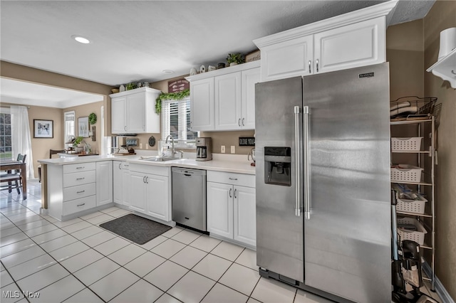 9013 Elsmere Dr, Parma, OH 44130 - kitchen featuring appliances with stainless steel finishes, white cabinetry, light countertops, and recessed lighting