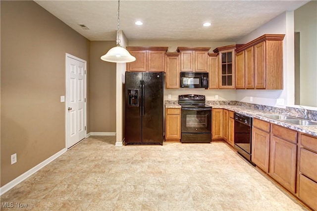 9111 Devonshire Dr, Olmsted Falls, OH 44138 - kitchen featuring black appliances, brown cabinets, glass insert cabinets, pendant lighting, and recessed lighting