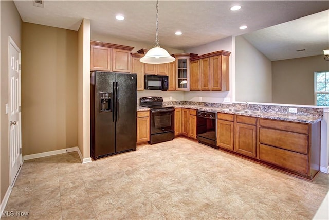 9111 Devonshire Dr, Olmsted Falls, OH 44138 - kitchen featuring black appliances, brown cabinetry, a peninsula, light stone counters, and pendant lighting