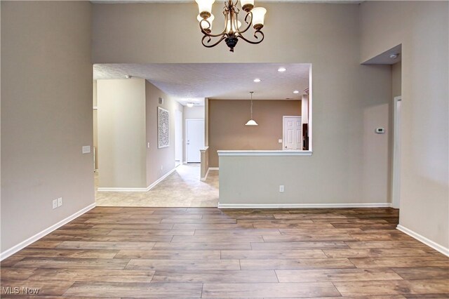 9111 Devonshire Dr, Olmsted Falls, OH 44138 - unfurnished room featuring wood finished floors, a chandelier, and recessed lighting