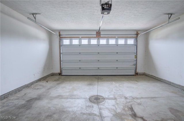 9111 Devonshire Dr, Olmsted Falls, OH 44138 - garage with a garage door opener and baseboards