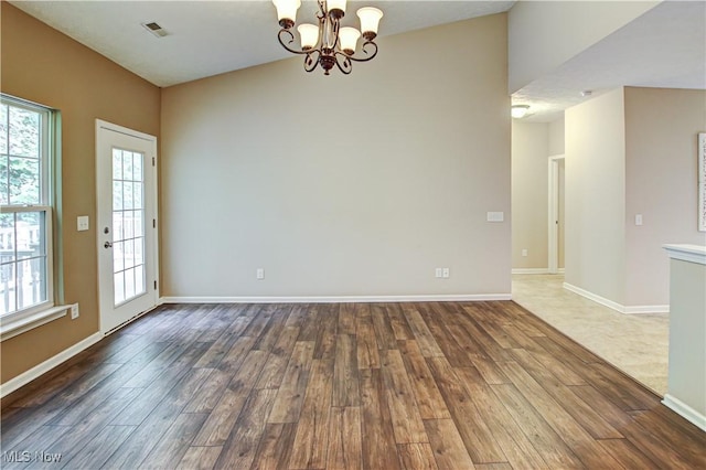 9111 Devonshire Dr, Olmsted Falls, OH 44138 - unfurnished room with dark wood finished floors and a chandelier