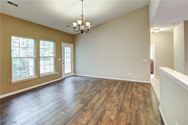 9111 Devonshire Dr, Olmsted Falls, OH 44138 - empty room featuring dark wood finished floors and a chandelier