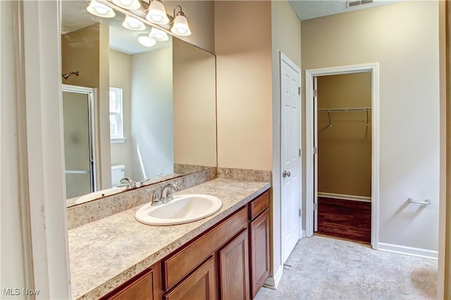 9111 Devonshire Dr, Olmsted Falls, OH 44138 - bathroom featuring a shower stall, vanity, and a spacious closet