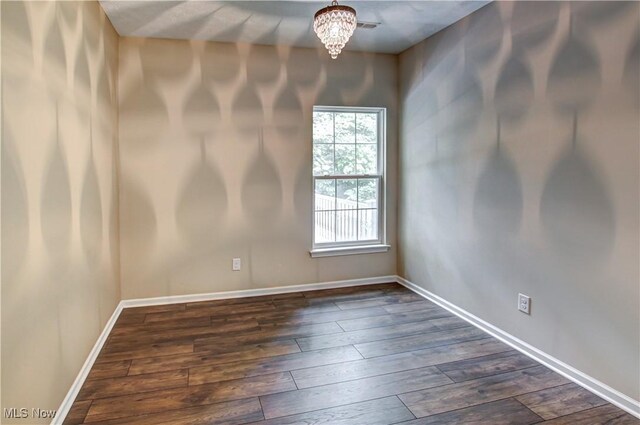 9111 Devonshire Dr, Olmsted Falls, OH 44138 - empty room featuring dark wood-style flooring and a chandelier