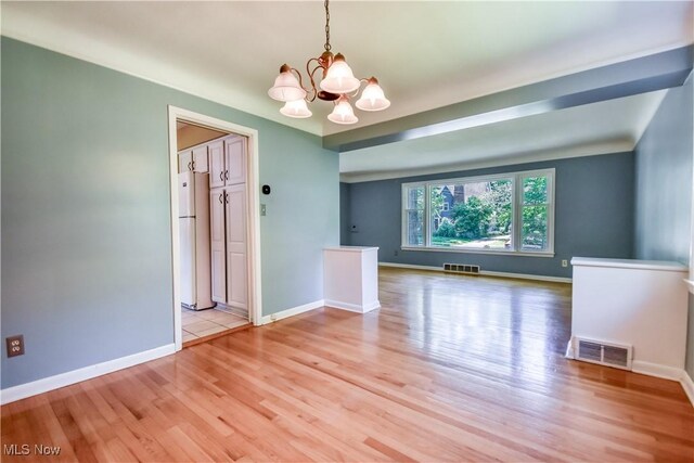 2607 Ashurst Rd, University Heights, OH 44118 - spare room with a chandelier and light wood-style flooring