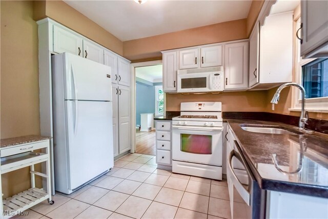 2607 Ashurst Rd, University Heights, OH 44118 - kitchen featuring white appliances, white cabinets, and light tile patterned floors