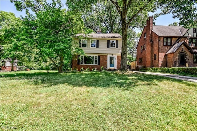 2607 Ashurst Rd, University Heights, OH 44118 - colonial house with a front lawn, a chimney, and brick siding
