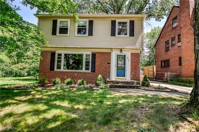 2607 Ashurst Rd, University Heights, OH 44118 - colonial home with a front lawn and brick siding