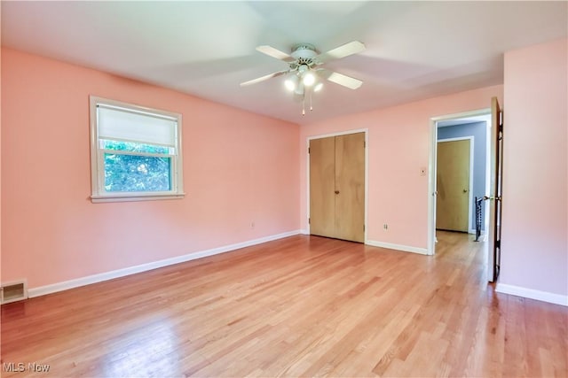 2607 Ashurst Rd, University Heights, OH 44118 - unfurnished bedroom with light wood-style flooring and a ceiling fan