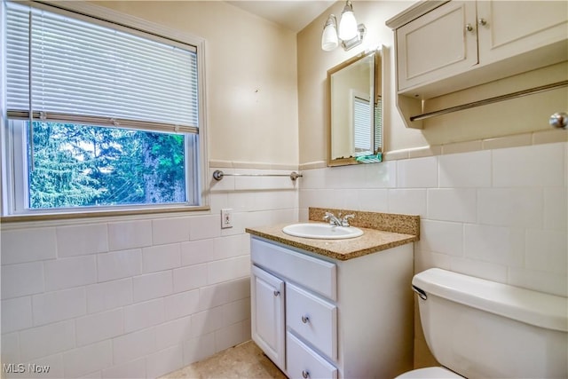 2607 Ashurst Rd, University Heights, OH 44118 - half bathroom with tile walls, vanity, and wainscoting