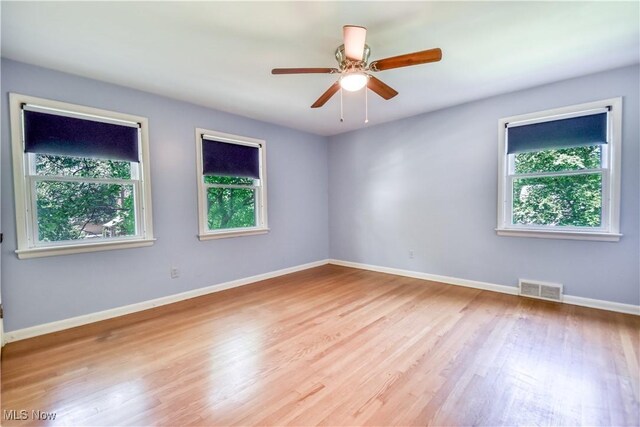 2607 Ashurst Rd, University Heights, OH 44118 - empty room with healthy amount of natural light, wood finished floors, and a ceiling fan