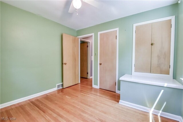 2607 Ashurst Rd, University Heights, OH 44118 - unfurnished bedroom with light wood-style floors and ceiling fan