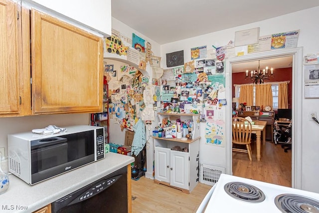 1387 Glenview Rd, Toledo, OH 43614 - kitchen featuring a chandelier, black dishwasher, light wood-type flooring, light countertops, and range