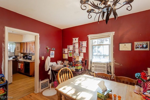 1387 Glenview Rd, Toledo, OH 43614 - dining room with a chandelier, cooling unit, and light wood-style flooring