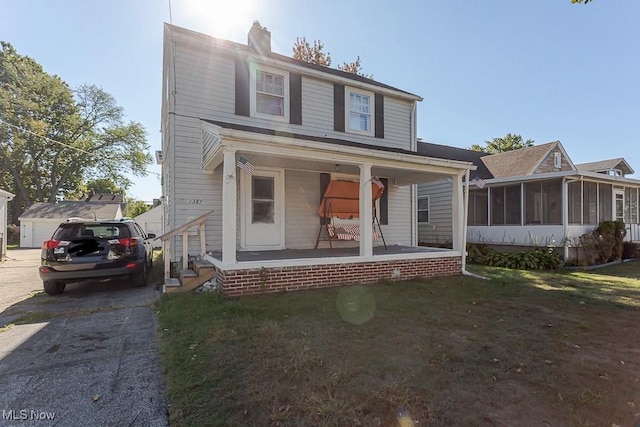 1387 Glenview Rd, Toledo, OH 43614 - view of front facade featuring covered porch, a sunroom, a chimney, and a front yard
