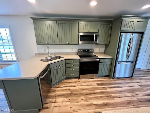 507B Memory Ln, Bethesda, OH 43719 - kitchen featuring stainless steel appliances, green cabinetry, light wood-style flooring, light countertops, and recessed lighting