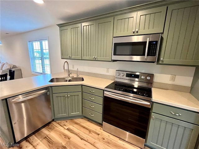 507B Memory Ln, Bethesda, OH 43719 - kitchen featuring stainless steel appliances, green cabinetry, light wood finished floors, light countertops, and recessed lighting