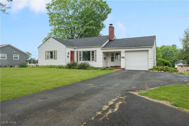 1005 Fairview Blvd, Coshocton, OH 43812 - ranch-style home with an attached garage, a chimney, a front lawn, driveway, and a shingled roof