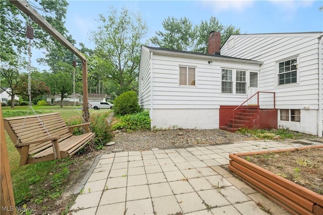 1005 Fairview Blvd, Coshocton, OH 43812 - rear view of house with a patio and a chimney