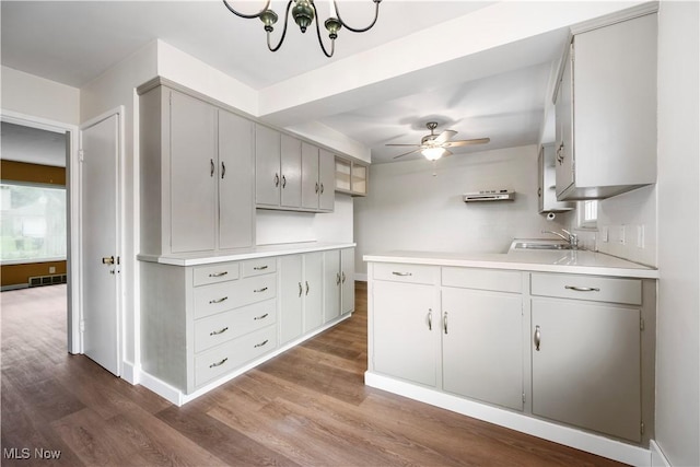 1005 Fairview Blvd, Coshocton, OH 43812 - kitchen with wood finished floors, light countertops, ceiling fan, a chandelier, and gray cabinetry