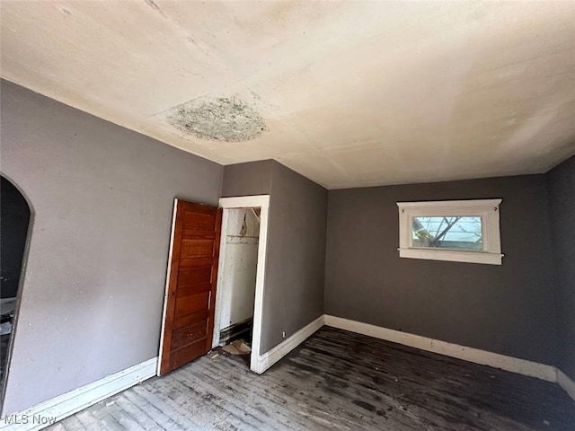 4039 Peak Ave, Toledo, OH 43612 - unfurnished bedroom with wood finished floors, arched walkways, and a closet
